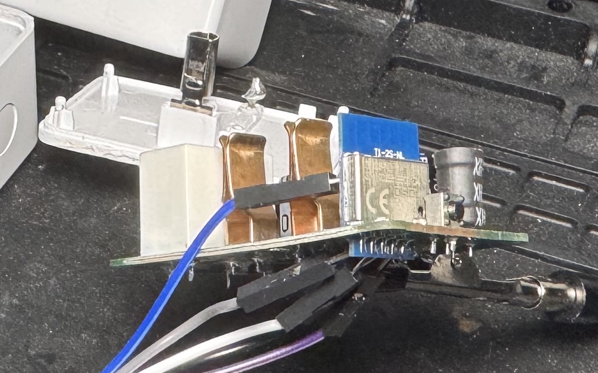 Close up of the board edge on, showing the WiFi module as a separate board soldered onto the main PCB, with serial jumpers attached
