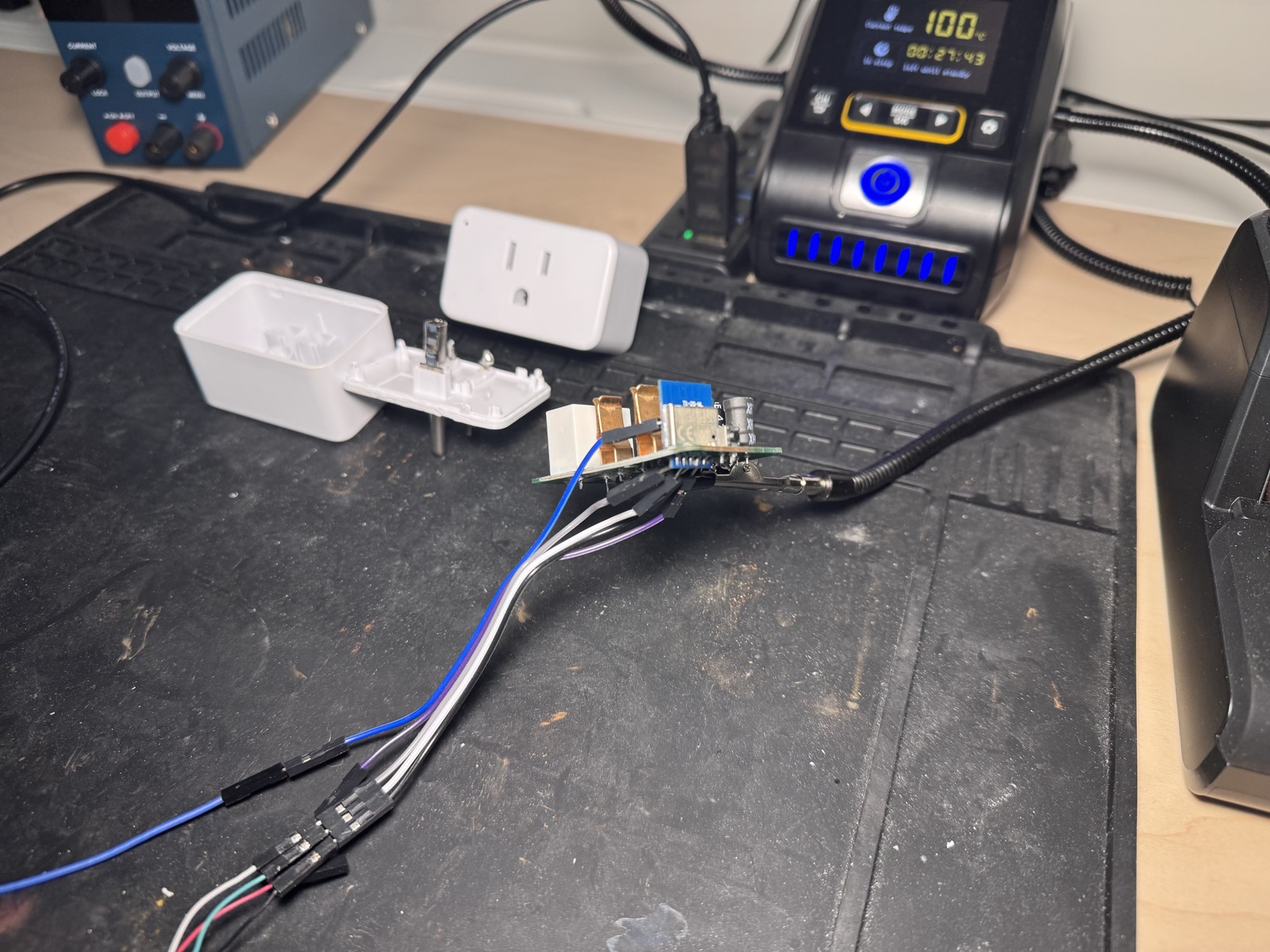 The plug opened on the bench, case in two halves, board wired up for serial